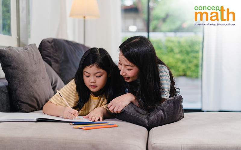 Mother guiding her daughter with her homework