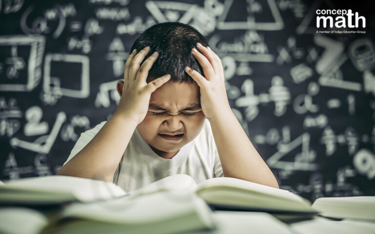 A child looks frustrated while trying to solve math problems
